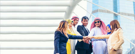 Banner Happy Diversity Teams multiethnic Partners standing with hands together in modern city. Panorama Teamwork group of multi racial confident happiness people joining trust teams partners outdoorの写真素材