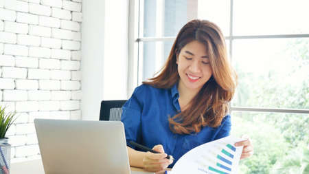Happiness Asian Woman working from home using laptop online meeting in home office. Happy relax time...