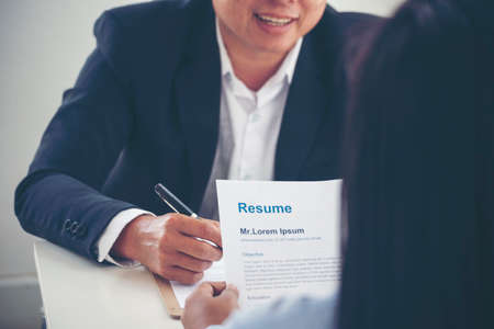 Businessman job interview by human resource HR officer interviwing, talk new employee shaking hands in office with smiling face. HR Manager interview check resume, face to face. Job Interview Conceptの写真素材