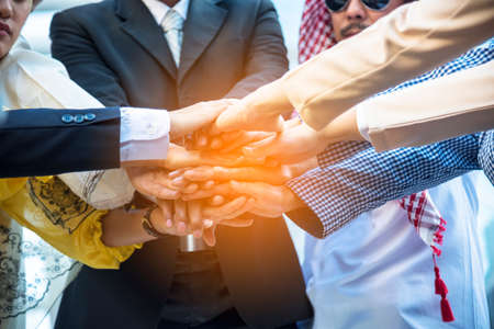 Diverse multiethnic Partners hands together teamwork group of multi racial people meeting join hands...