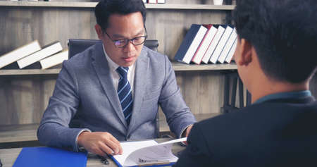 Job HR applicants having an interview with Human resource manager jobs interviewing with confident candidate at business firm office give cv resume. Job Interview with headhunter agent and applicantの写真素材