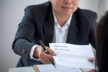 Businessman job interview by human resource HR officer interviwing, talk new employee shaking hands in office with smiling face. HR Manager interview check resume, face to face. Job Interview Conceptの写真素材