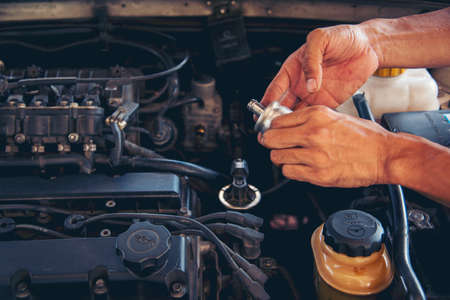 Close up Man hands fixing Car machinery vehicle mechanical service. Mechanic man hands repairing car...