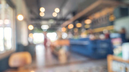 Blurred background shopping mall light bokeh business event in retail store. Blurry abstract background of store grocery. Blur Convention hall center audience present display goods products on shelf.の写真素材