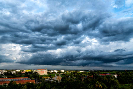 Dramatic dark storm rain clouds black sky background. Dark thunderstorm clouds rainny atmosphere. Meteorology danger windstorm disasters climate. Dark cloudscape storm disaster gloomy gray cloud skyの写真素材