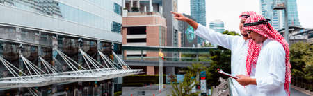 Banner Arab team hold digital tablet uae union teamwork people. Panorama arab group of people using...