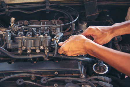 Close up Man hands fixing Car machinery vehicle mechanical service. Mechanic man hands repairing car...