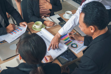 Group of business people meeting in conference room brainstorming consult business document graph chart office desk. Diversity multiethnic group of business people brainstorming and working together.の写真素材