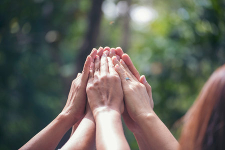 Diversity multiethnic high five group of business people success team hands together. Collaborate Volunteer friendship hands raise up mission Business partner. Group of teamwork high five togetherの写真素材
