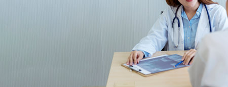 Banner Two asian women doctors discuss meeting office medical clinic. Young asian female doctor...