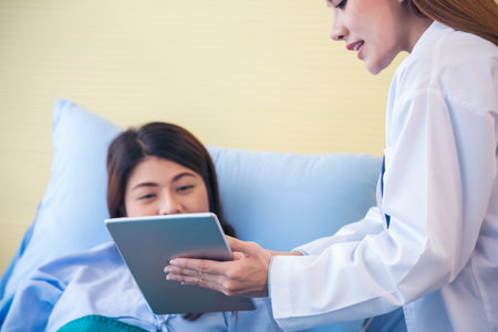 Woman doctor and patient consultation with professional specialist diagnostics at hospital medicare treatment clinic. Doctor talking to patient for medical health care therapy. Healthy medical conceptの写真素材
