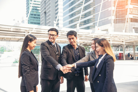 Multiethnic Teamwork friendship group brainstorming togetherness. Business people team holding hands Solidarity. Diversity business partner people teamwork holding hands together power of tag teamの写真素材