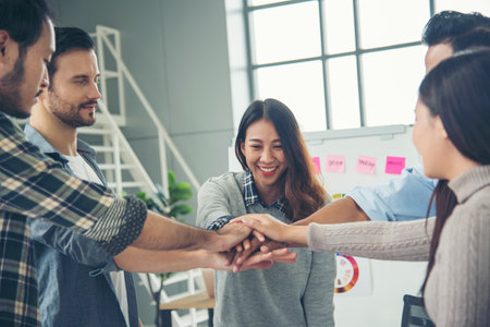 Diversity volunteer Teamwork friendship holding hands together. Multiethnic Business people team Solidarity charity. Team partner people teamwork holding hands together power of tag team partnership.の写真素材