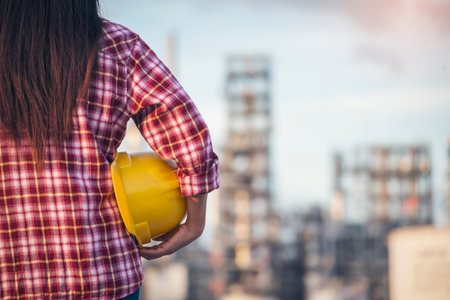 Woman construction engineer wear safety white hard hat at construction site industry worker. Female engineer worker civil engineering with hard hat safety helmet. Woman construction Engineer conceptの写真素材