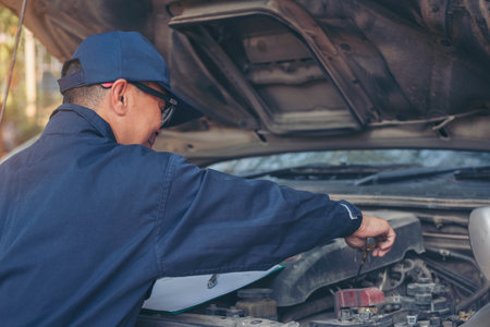 Mechanic car service auto garage in automotive mobile center. Technician workshop repair engine motor vehicles service mechanical engineering business. Automobile mechanic hands car repairs technicの写真素材