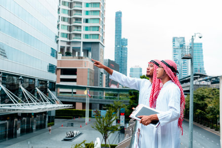 Arab team hold digital tablet uae union teamwork people. Digital marketing arab group of people using smart tablet discuss modern muslim UAE city. Entrepreneur Asian people smile teams meeting.の写真素材
