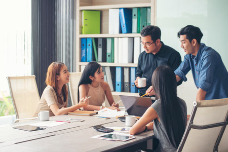 Group of business people meeting in conference room brainstorming consult business document graph chart office desk. Diversity multiethnic group of business people brainstorming and working together.の写真素材