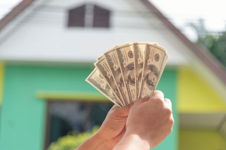 Hand holding loan money dollar bank note give financial payment. Man hands showing spread 100 dollar exchange cash payout. Saving Businessman counting money banknote  bribe corruption concept.の写真素材