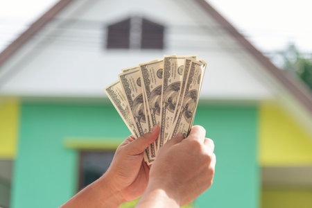 Hand holding loan money dollar bank note give financial payment. Man hands showing spread 100 dollar exchange cash payout. Saving Businessman counting money banknote  bribe corruption concept.の写真素材