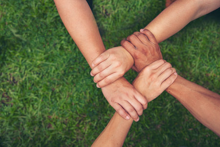 Diverse multiethnic Partners hands together teamwork group of multiracial people meeting join hands togetherness. Diversity people hands join empower partnership teams connection volunteer communityの写真素材
