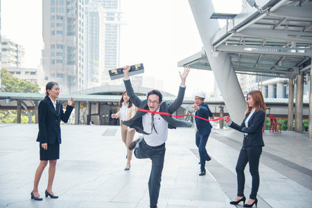 Business competition group of business people in formal suit run to finish line success goal victory strategy. Competitive person race to be first place winner. Multiethnic diversity people contest.の写真素材