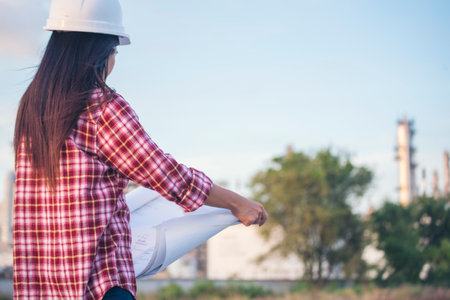Woman construction engineer wear safety white hard hat at construction site industry worker. Female engineer worker civil engineering with hard hat safety helmet. Woman construction Engineer conceptの写真素材