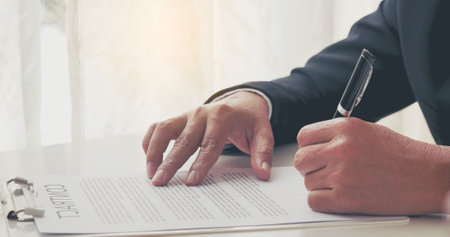 Businessman hand using pen signing on new contract to starting projects in conference room. Close up business manager man hands sign contract legal document in meeting room. Business agreement conceptの写真素材