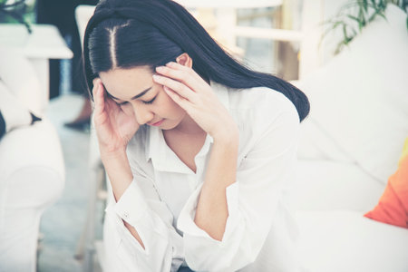 Stress asian women headache have migraine feeling temples stressfull upset depressed. Strong headache migraine exhausted young girl. Office syndrome unhealthy Tension person. Woman headache conceptの写真素材