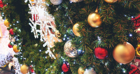Colourful glittering baubles ornament ball decorated christmas tree on holiday winter xmas happy new year festival celebration. Red, gold, silver ball on Christmas tree. Merry Christmas happy new yearの写真素材