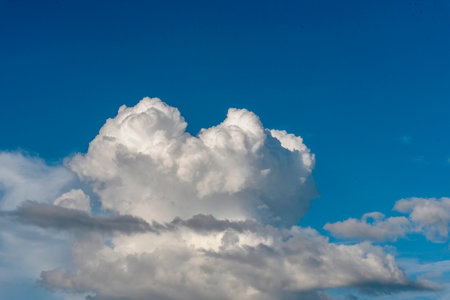 Blue sky fluffy white clouds on summer season bright clear skyline with beautiful cloudscape. Panorama blue sky clouds pattern on daylight with copy space. Cumulus cloudscape air climate sunny dayの写真素材