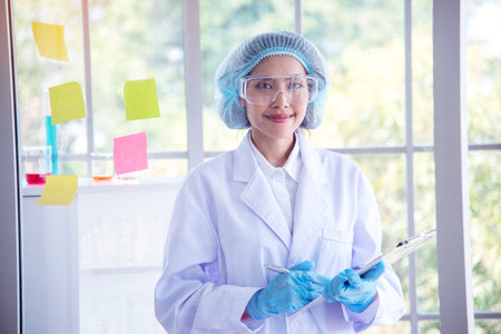 Portrait Asian women scientist laboratory background. female research pathologist clinician expert medical chemist. Woman expertise scientist portrait in medical lab. Happiness biology lab womanの写真素材