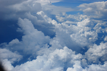 Blue sky fluffy white clouds on summer season bright clear skyline with beautiful cloudscape. Panorama blue sky clouds pattern on daylight with copy space. Cumulus cloudscape air climate sunny dayの写真素材
