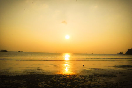 Tropical sea beach in summer time on sunny day. Golden sand beach sea peaceful scenery on the beach. Travel vacation seaside outdoor. Ocean island beautiful dramatic landscape. Sunny seascape scene.の写真素材