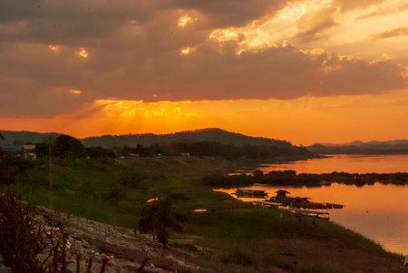 Silhouette tranquil season wilderness serene landscape. Tranquil lake countryside sunrise seaside reflection. Tropical amazing dramatic golden sky on sunset over scenic river lake seascape ocean.の写真素材