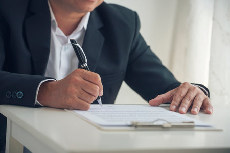 Asian business man using pen signing on new contract to starting projects in conference room. Close up manager businessman hands sign contract working meeting. Business agreement concepts.の写真素材