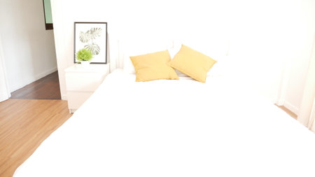 Blur background bedroom home interior in cozy decoration room. Clean soft bed stylish decor relax dorm with copy space. Modern apartment white light trendy style. Blurred background defocused indoorsの写真素材
