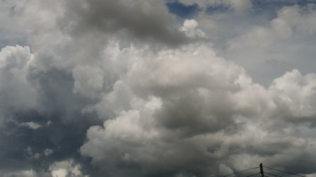 Dark rain cloud dramatic sky summer tropical thunder storm sky and fluffy black darkness cloud nearly raining cloudscape. Nimbus raincloud skyline climate background. Dark gray sky cloudy environmentの写真素材