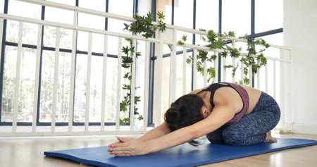 Women yoga meditation stretching back, arm meditate home fitness on floor. Happiness Young women doing yoga Balasana child pose. Wellness woman in sportswear meditate relaxation stretch health careの写真素材