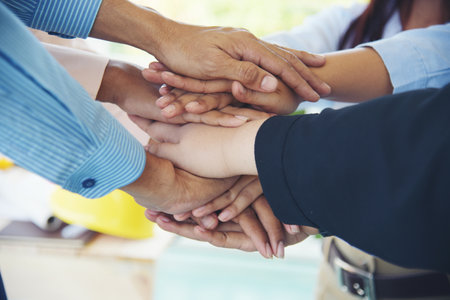 Close up hands Diverse multiethnic Partners team together. Teamwork group of multi racial people...