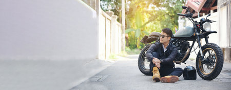 Banner Asian man with a motorbike in black leather jacketの写真素材