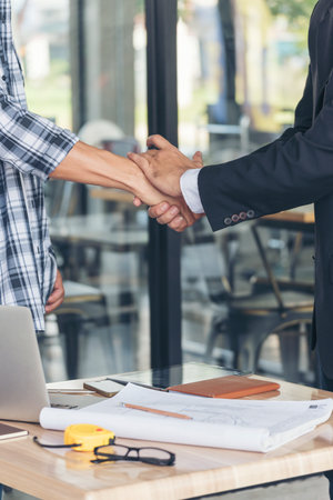 Teamwork partner two men team shaking hands together. Businessman contractor handshake with Business Partner Trust Partnership. Industrail people contractor dealing mission team meeting office deskの写真素材