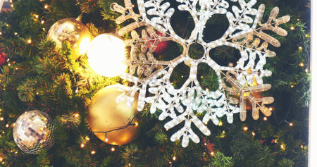 White snowflake colourful glittering baubles ornament ball decorated christmas tree. Holiday winter xmas happy new year festival decoration. Snowflake ball on Christmas tree. Merry Christmas decorateの写真素材
