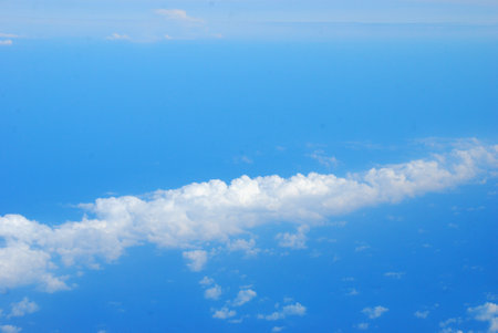 Blue sky fluffy white clouds on summer season bright clear skyline with beautiful cloudscape. Panorama blue sky clouds pattern on daylight with copy space. Cumulus cloudscape air climate sunny dayの写真素材