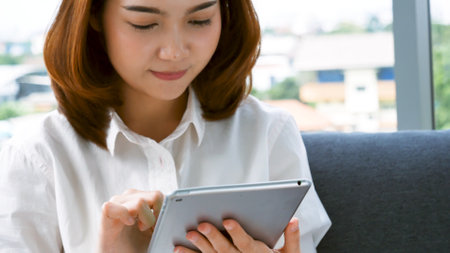 Asian woman using digital tabletの写真素材