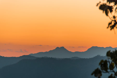 Sunset mountain range beautiful landscape mist, dusk golden time dramatic sky. Beautiful landscape high mountain ridge mist panning panorama scenery dawn dramatic sky. Sunrise landscape mountain peak.の写真素材