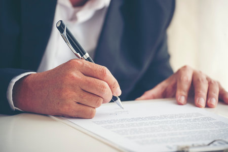 Businessman hand using pen signing on new contract to starting projects in conference room. Close up business manager man hands sign contract legal document in meeting room. Business agreement conceptの写真素材