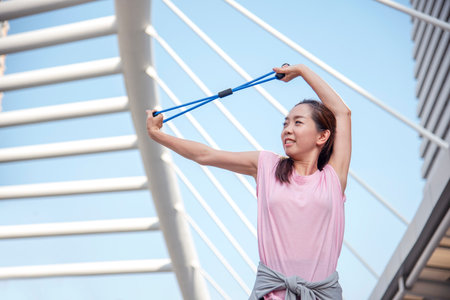 Sport Fitness Woman stretching body exercise in modern city outside.の写真素材