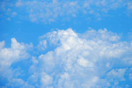 Blue sky fluffy white clouds on summer season bright clear skyline with beautiful cloudscape. Panorama blue sky clouds pattern on daylight with copy space. Cumulus cloudscape air climate sunny dayの写真素材
