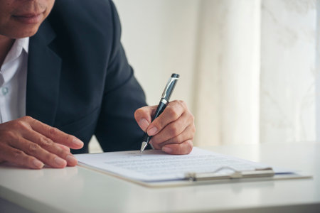 Asian business man using pen signing on new contract to starting projects in conference room. Close up manager businessman hands sign contract working meeting. Business agreement concepts.の写真素材
