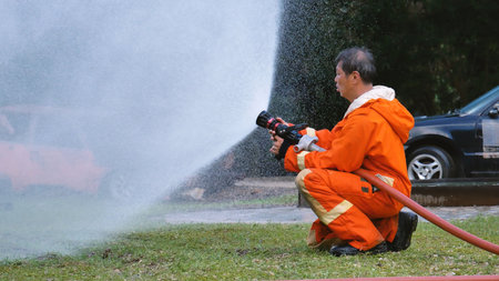 Firefighter Rescue team training in fire fighting extinguisher. Firefighter teamwork fighting with...